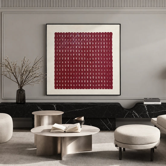 Burgundy Rhythm artwork displayed above seating and low tables against a paneled wall.