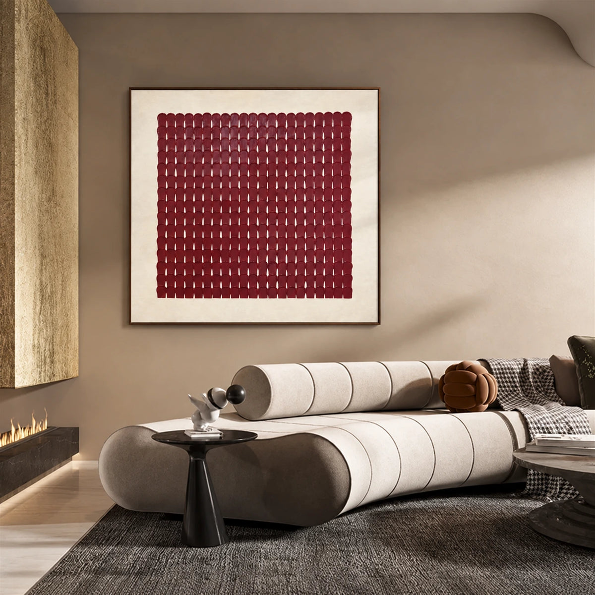 Burgundy Rhythm artwork displayed above a rounded sofa in warm sunlight.