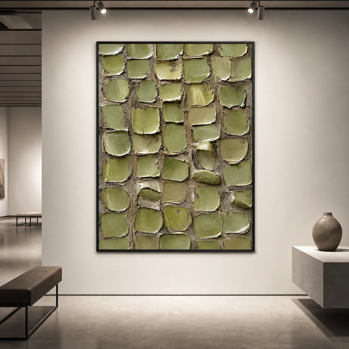 Olive Tessera artwork displayed above a low console on a softly lit wall.