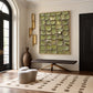 Olive Tessera artwork displayed above a wooden bench beside tall windows.