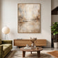 Gilded Haze artwork displayed above a wooden sideboard beside lounge seating.