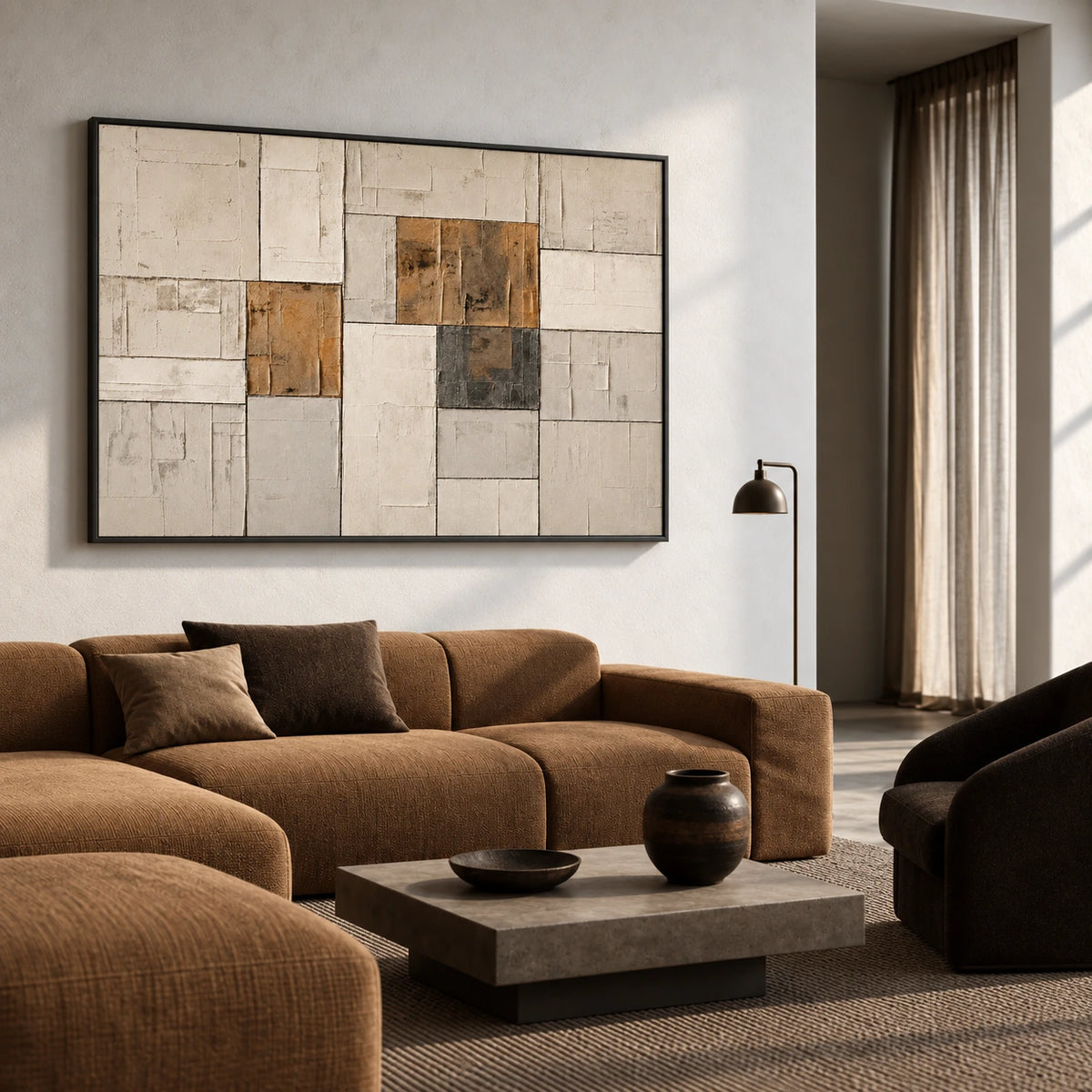 Ochre Masonry artwork displayed above a curved brown sofa.