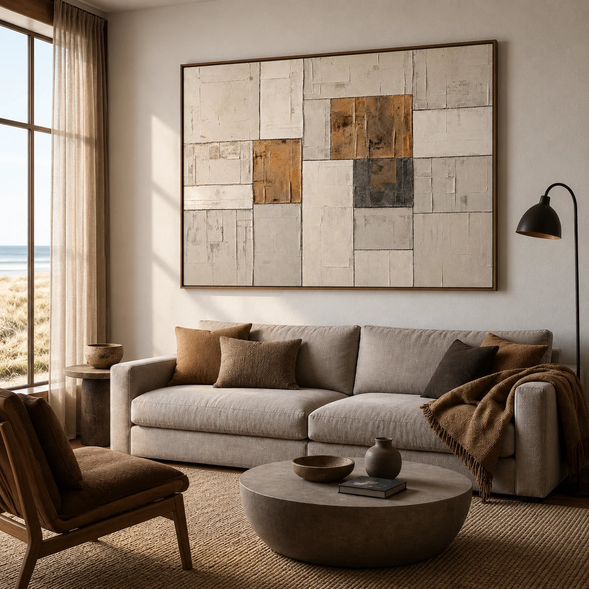 Ochre Masonry artwork displayed above a neutral sofa beside a window.