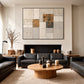 Ochre Masonry artwork displayed above a black sofa in a warm living room.