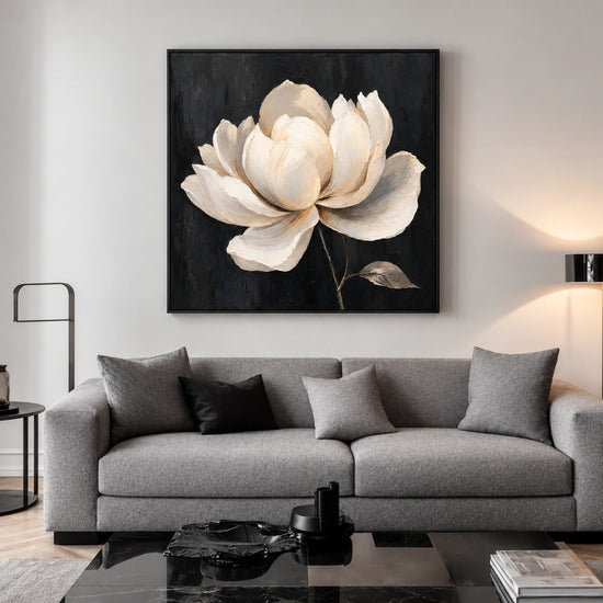 Ivory Magnolia artwork displayed above a gray sofa in a bright lounge.