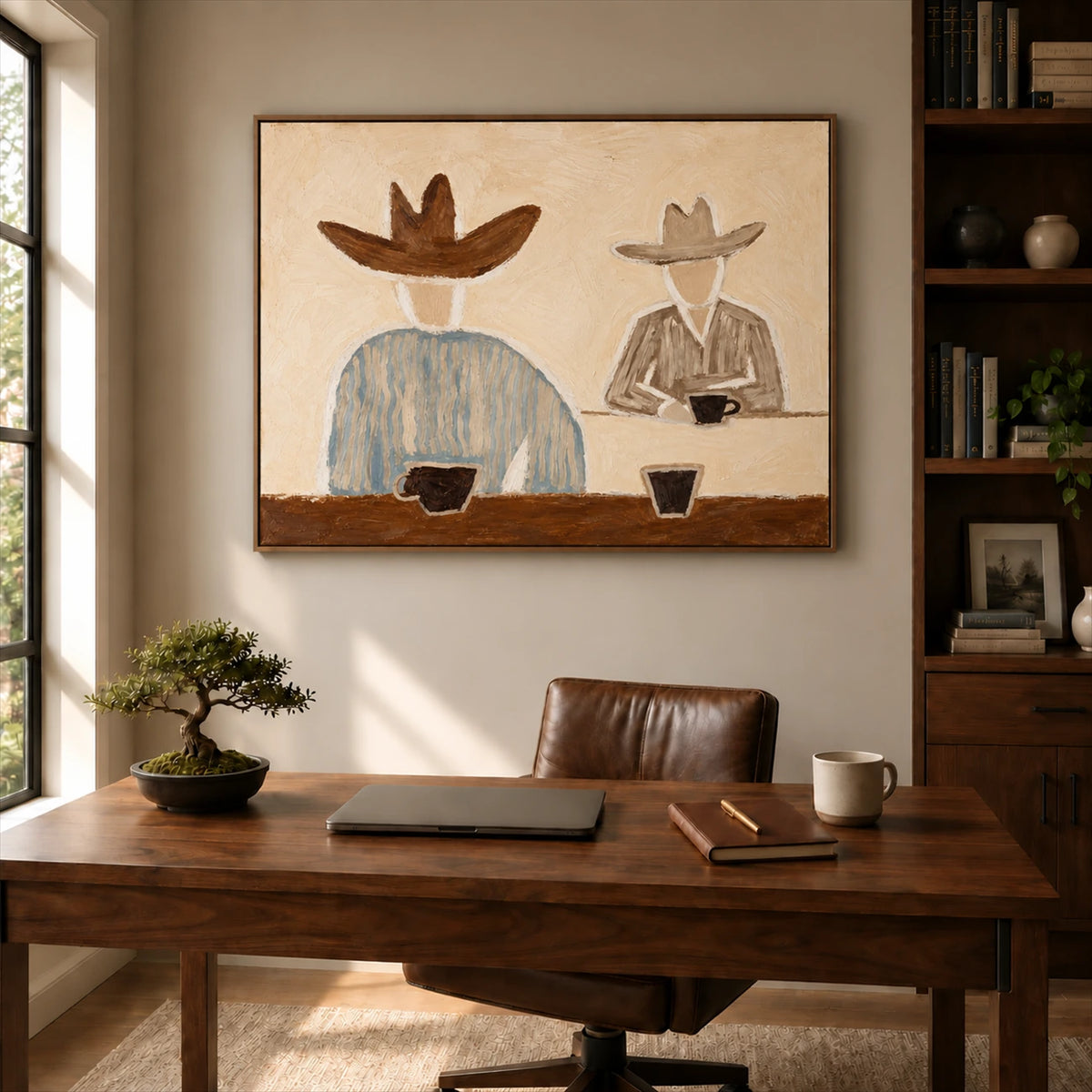 Saddlebreak Coffee artwork displayed above a wooden desk beside shelves.