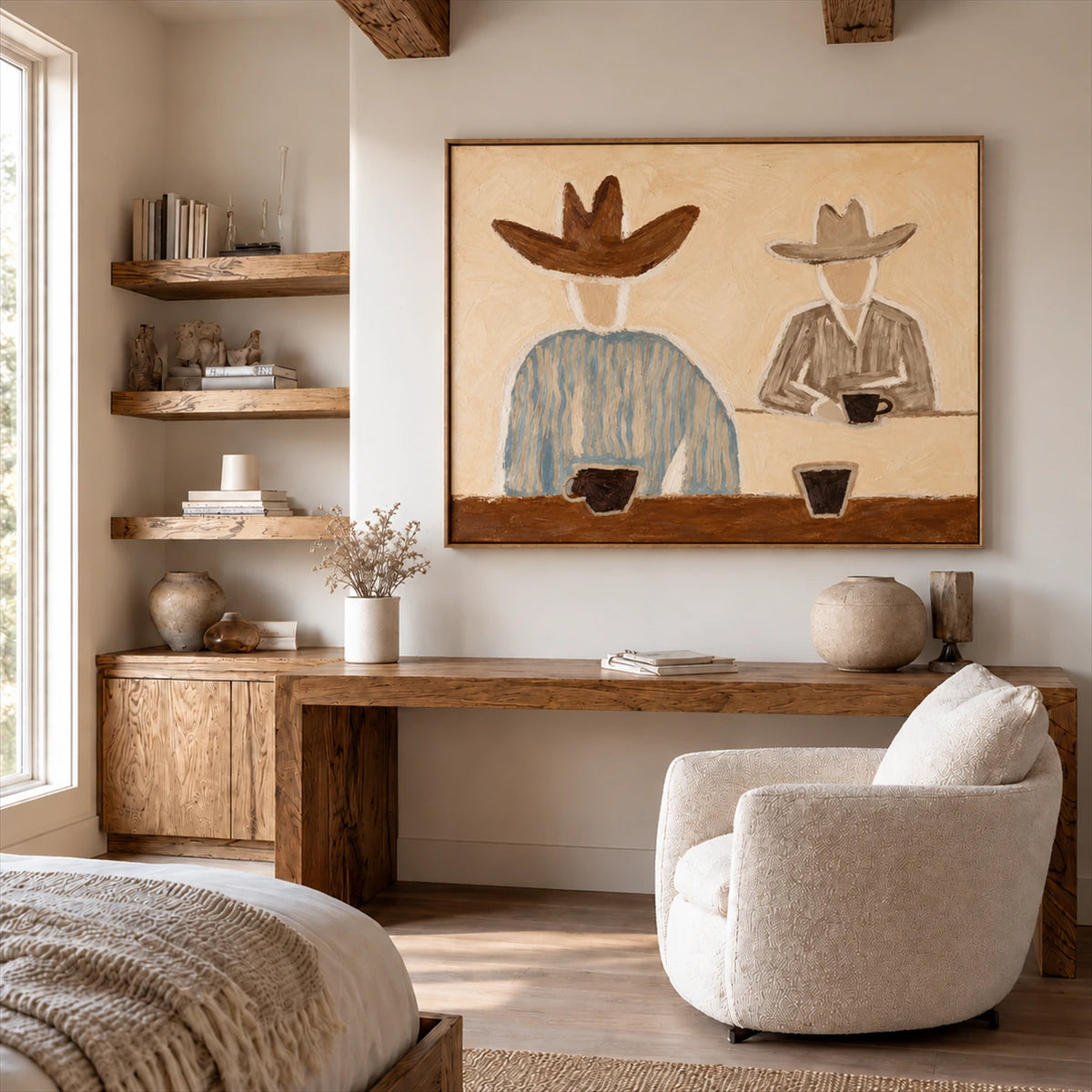 Saddlebreak Coffee artwork displayed above a console beside a pale armchair.