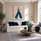 Indigo Stride artwork displayed above a cream sofa with blue cushions.