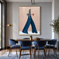 Indigo Stride artwork displayed above a wooden dining table and blue chairs.