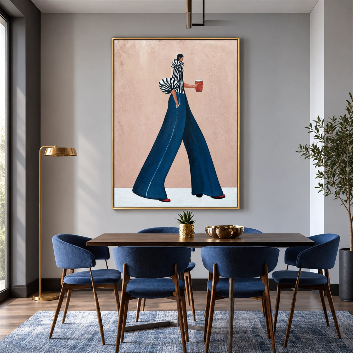 Indigo Stride artwork displayed above a wooden dining table and blue chairs.
