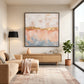 Gilded Blush artwork displayed above a low cabinet in a bright living room.