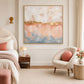 Gilded Blush artwork displayed beside a bed with soft pink bedding.