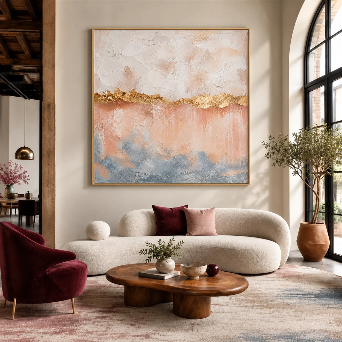 Gilded Blush artwork displayed above a cream sofa and round wooden coffee table.