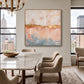 Gilded Blush artwork displayed above a console behind a dining table.
