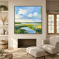 Tidal Meadow artwork displayed above a fireplace in a bright living room.