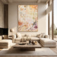 Amber Traces artwork displayed above a cream sectional in a bright living room.