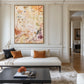Amber Traces artwork displayed above a white sofa against paneled walls.