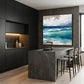 Azure Breakers artwork displayed above a dark stone kitchen island.