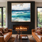 Azure Breakers artwork displayed above a fireplace between tall windows.