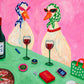 Bistro Ducks full artwork. Two stylish ducks in patterned headscarves share a green table set with wine glasses and colorful small objects.