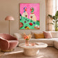 Bistro Ducks artwork displayed above a cream sofa beside a pink lounge chair.