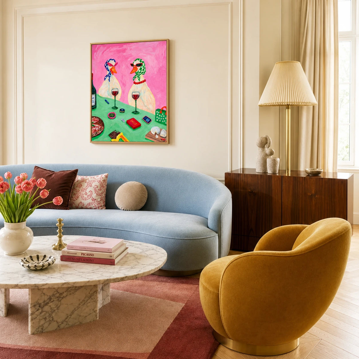 Bistro Ducks artwork displayed above a blue sofa beside a mustard lounge chair.