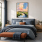 Pastel Estuary artwork displayed above a blue upholstered bed.