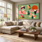 Patchwork Migration artwork displayed above a cream sectional beside bright windows.