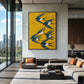 Saffron Swallows artwork displayed above a gray sectional beside tall windows.