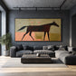 Twilight Trot artwork displayed above a gray sectional beneath a concrete ceiling.