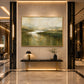 Mosslit Water artwork displayed above a slim console in a warm lobby.