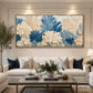Porcelain Foliage artwork displayed above a cream sofa with blue cushions.