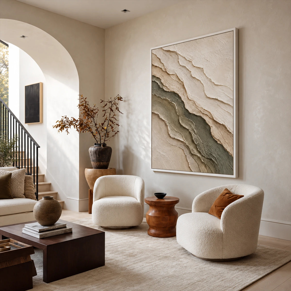 Quiet Strata artwork displayed above rounded cream armchairs.