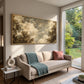 Clouded Canopy artwork displayed above a pale sofa beside a garden window.
