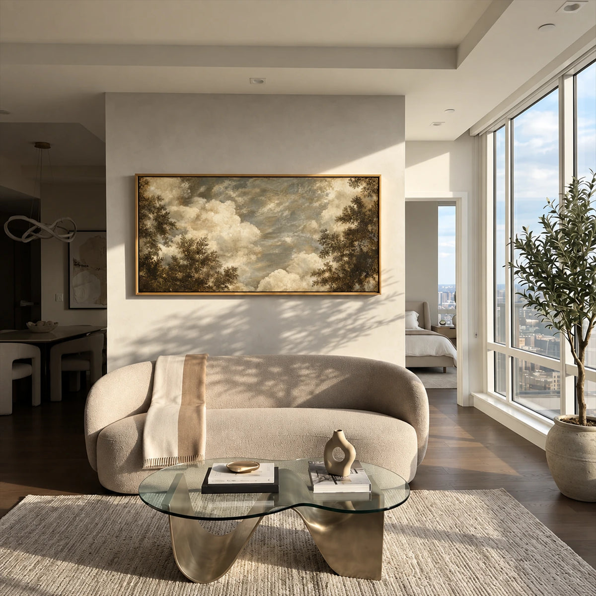 Clouded Canopy artwork displayed above a rounded cream sofa.