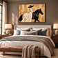 Ivory Cavalier artwork displayed above a cream upholstered bed.