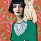 Feline Muse full artwork. A woman with a dark bob and a lace-trimmed green dress shares the frame with a pale cat perched on her shoulder.