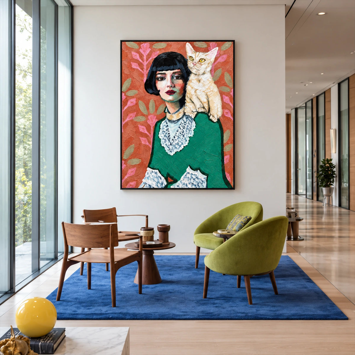 Feline Muse artwork displayed beside green and wooden chairs near tall windows.