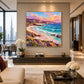 Prismatic Cove artwork displayed above a long console behind neutral seating.