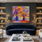 Cobalt Autumn artwork displayed above a dark blue curved sofa.