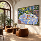 Sunlit Tea artwork displayed beside rounded brown lounge chairs.