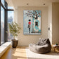 Birdsong Courtyard artwork displayed beside a gray floor cushion near a tall window.
