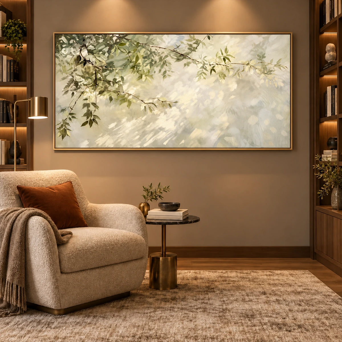 Dappled Branches artwork displayed above a pale armchair beside shelves.