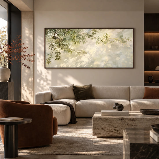 Dappled Branches artwork displayed above a light sofa behind a stone table.