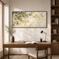 Dappled Branches artwork displayed above a wooden desk beside a window.