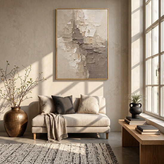 Ivory Fragments artwork displayed above a cream armchair.