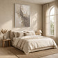 Ivory Fragments artwork displayed above a cream upholstered bed.