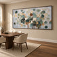 Eucalyptus Drift artwork displayed above a wooden desk and cream chair.