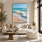 Sunwashed Breakers artwork displayed above a white sofa.