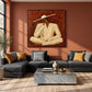 Sienna Contemplation artwork displayed above a dark sectional against a terracotta wall.